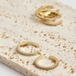 18k gold-tone slim ear cuffs featuring a continuous, delicate row of shimmering micro-pavé crystals along the outer rim