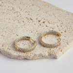 18k gold-tone medium-sized huggie hoops encrusted with three dense rows of shimmering micro-pavé crystals for a full-coverage sparkle