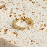 18k gold-tone ear cuff featuring a series of rectangular baguette-cut crystals in an alternating gold-bar channel setting