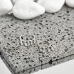 A pair of elegant, silver-tone hoop earrings adorned with delicate beading along the rim, featuring a cascading fringe of dainty, baguette-cut crystal charms