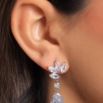 Silver-tone drop earrings featuring a trio of marquise-cut crystal "leaves" atop a singular round accent stone and a dramatic pear-cut drop