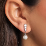 A refined silver-toned earring featuring a vertical row of brilliant-cut crystals leading to a smooth, dangling white pearl drop for a luminous, contemporary look