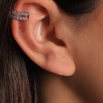 A sophisticated silver-tone ear cuff featuring two parallel bands encrusted with shimmering pavé crystals
