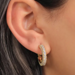 A pair of radiant gold-tone huggie hoops featuring a continuous, dazzling row of channel-set crystals