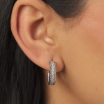 A pair of elegant, gold-toned hoop earrings featuring a center row of shimmering pavé crystals flanked by delicate, rope-textured metal detailing