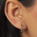 A pair of delicate silver-tone stud earrings featuring a clean, vertical line of small, brilliant-cut clear crystals