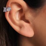 A refined ear cuff featuring a polished, high-shine metal band punctuated by evenly spaced, shimmering pavé-set stones